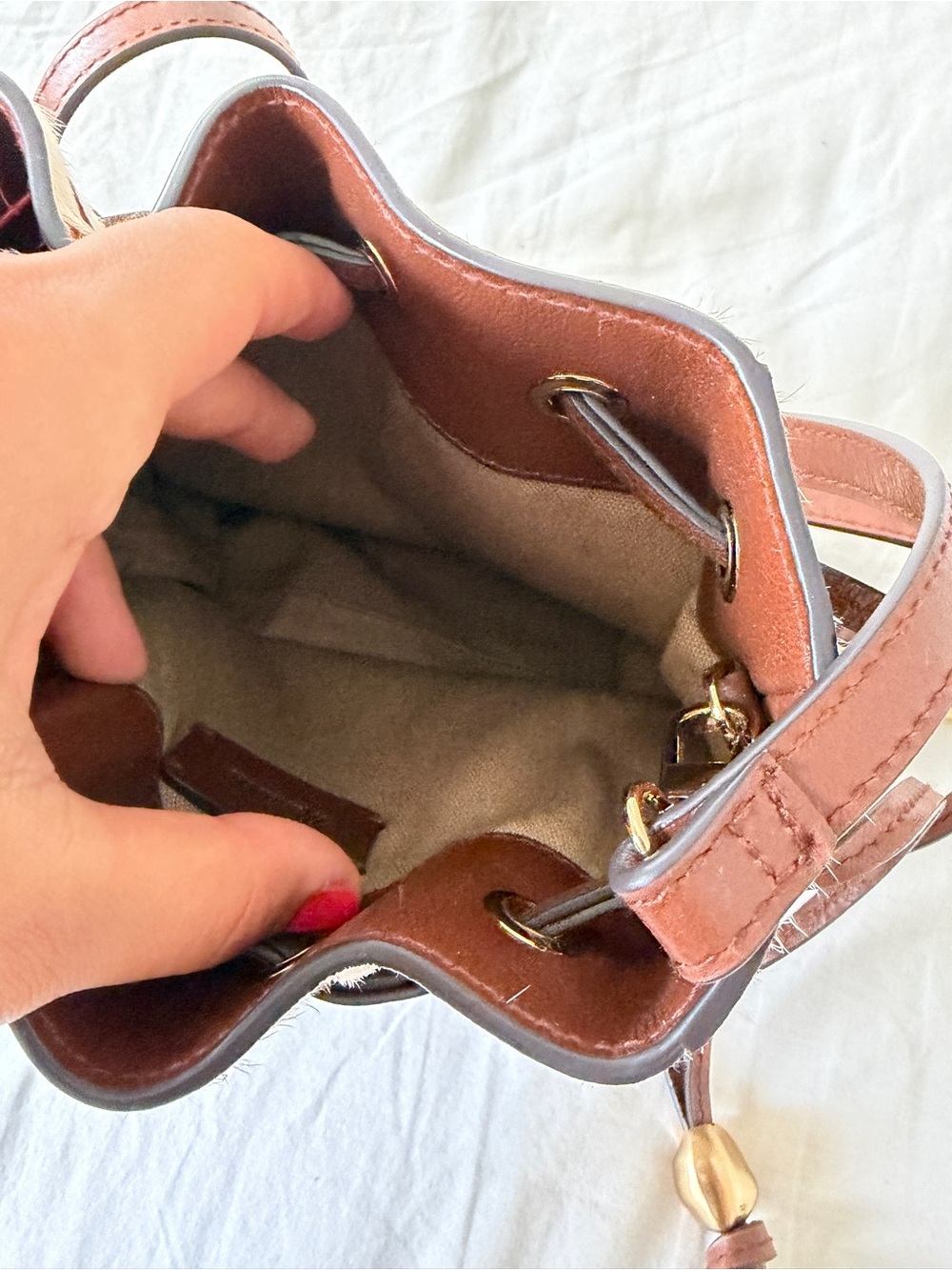 The Mini Drawstring Crossbody Bucket Bag Cow Print - Picture 10 of 11